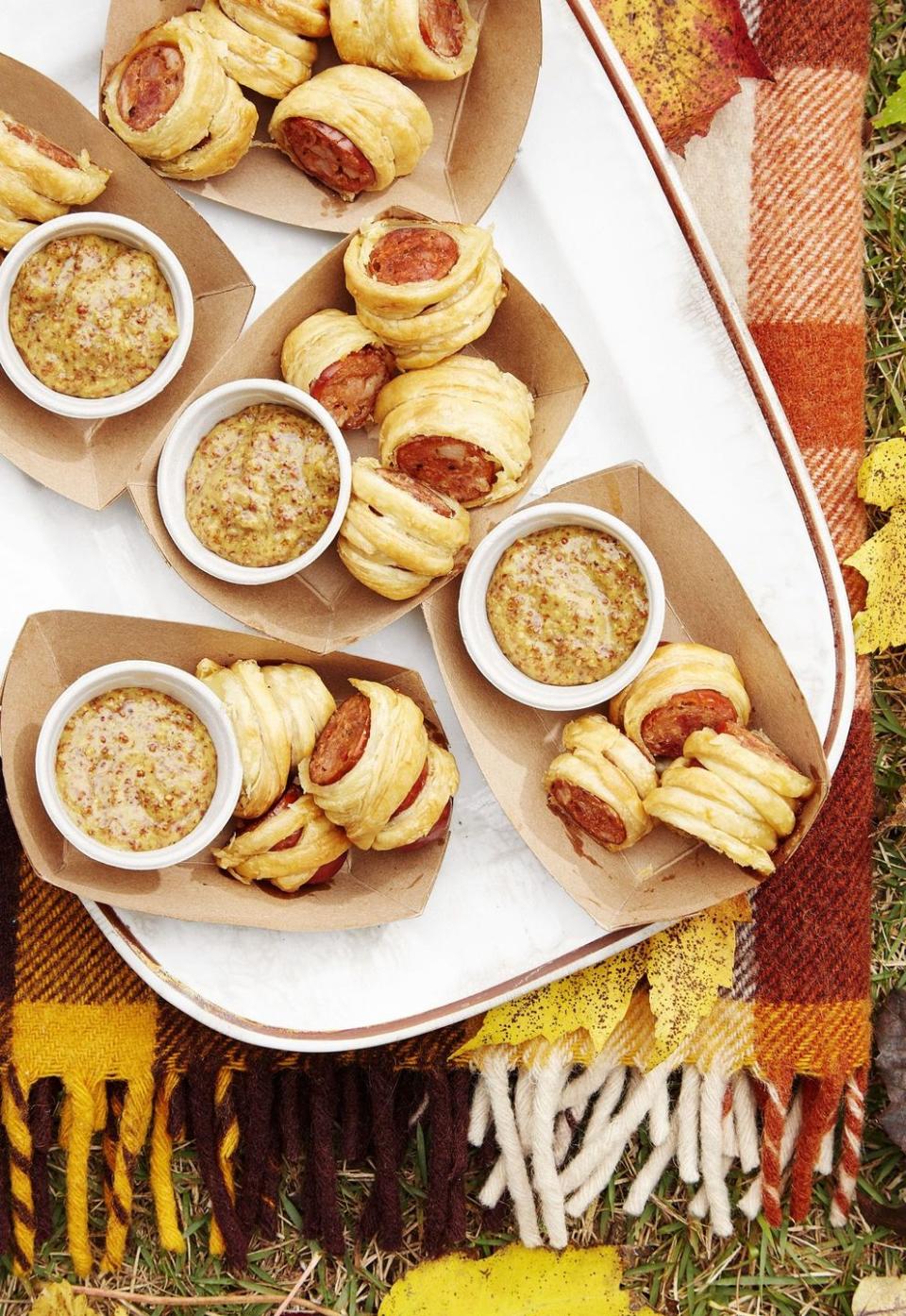 cajun sausage puffs made with puff pastry and served with small cups of bourbon mustard