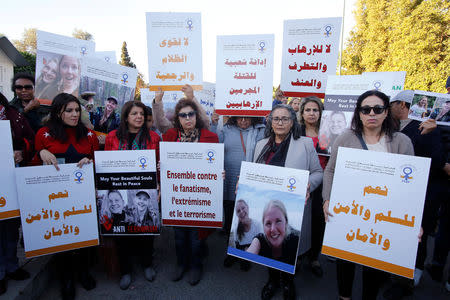 Moroccans gather in front of Denmark's embassy in Rabat to honour Maren Ueland from Norway and Louisa Vesterager Jespersen from Denmark, who were killed in Morocco, in Rabat, Morocco December 22, 2018. The placards read "Together against terrorism fanaticism extremism" and "Yes To Peace and Security". REUTERS/Youssef Boudlal