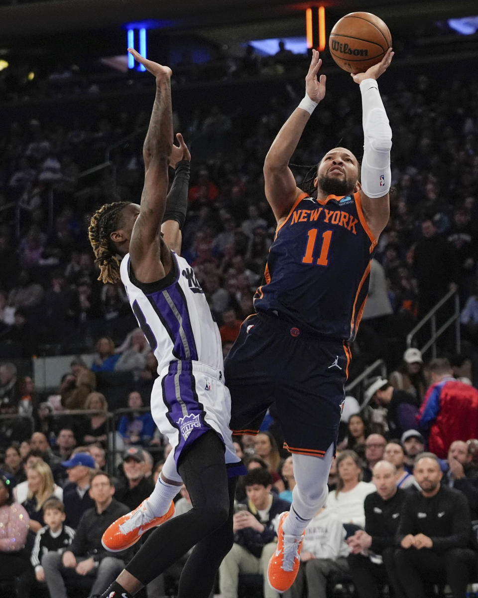 New York Knicks' Jalen Brunson, right, shoots next to Sacramento Kings' Keon Ellis during the first half of an NBA basketball game Thursday, April 4, 2024, in New York. (AP Photo/Frank Franklin II)