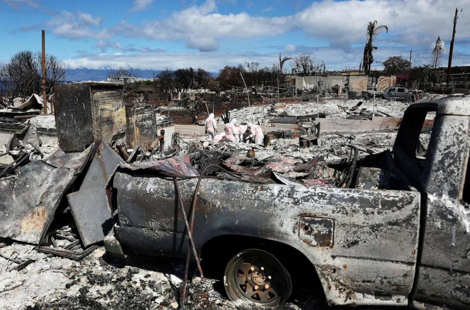 PHOTO: Volunteers from Samaritan's Purse help a daughter search for family items in the rubble of her mother's home destroyed in a wildfire in August, Oct. 9, 2023, in Lahaina, Hawaii. (Mario Tama/Getty Images)