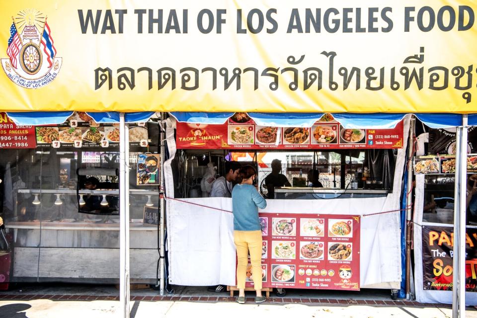 A row of booths at a food market.