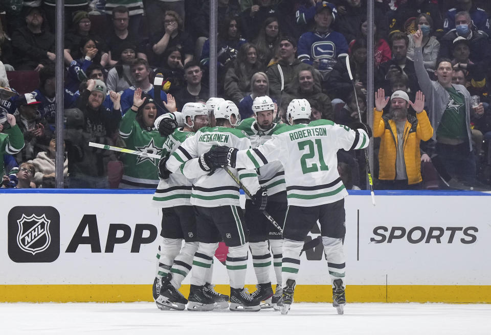 Dallas Stars' Jamie Benn, back right, celebrates his goal against the Vancouver Canucks with Joe Pavelski, Miro Heiskanen, Jason Robertson and Roope Hintz during the third period of an NHL hockey game Thursday, March 28, 2024, in Vancouver, British Columbia. (Darryl Dyck/The Canadian Press via AP)