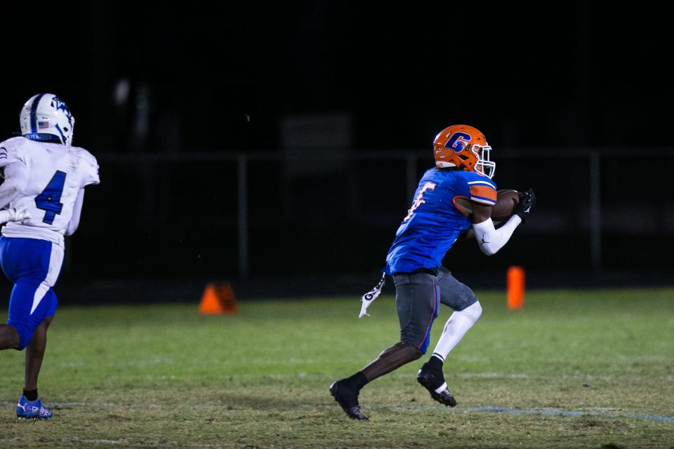 Palm Beach Gardens free safety Michael Wright III picks off a pass during the Class 4M regional quarterfinal game between Gardens and Wellington on Monday, November 14, 2022, in Palm Beach Gardens, FL. Wright is committed to FAU.