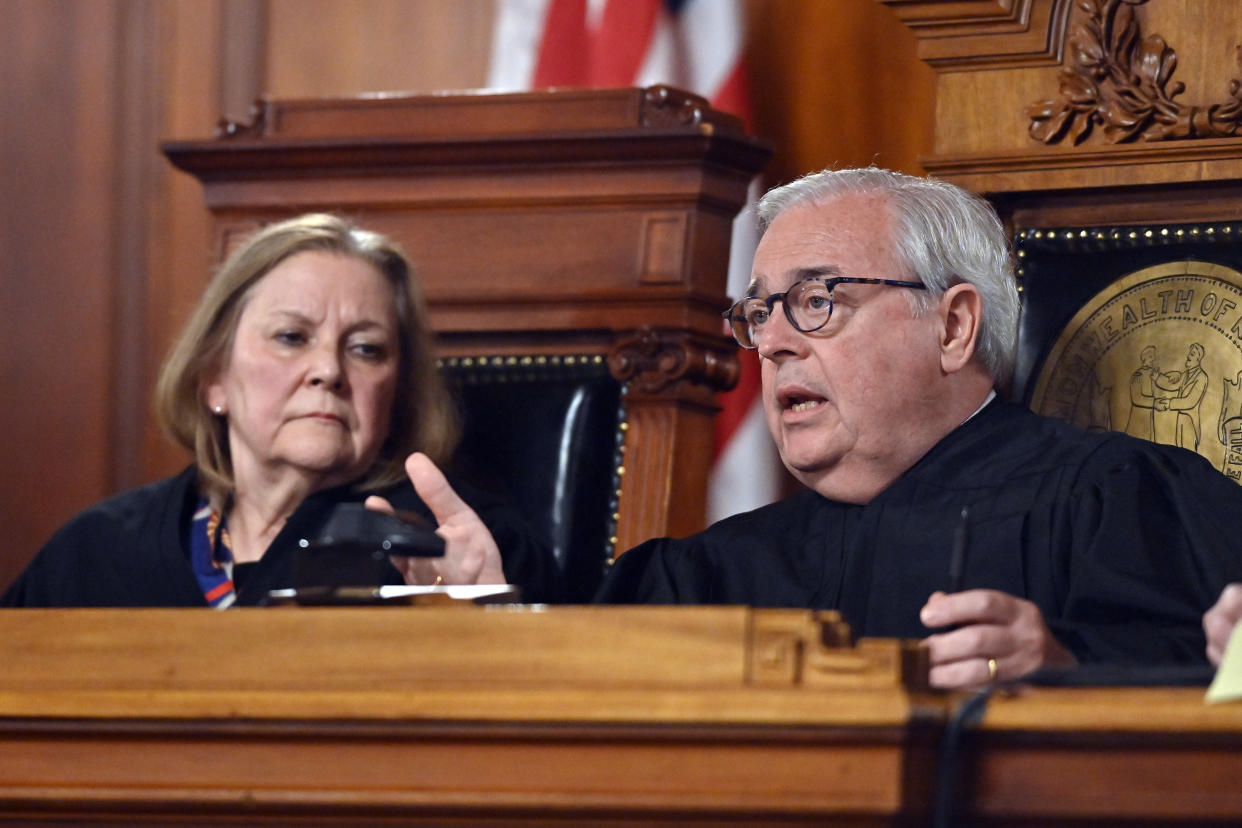 Kentucky Supreme Court Chief Justice John D. Minton Jr., right, asks a question to the Kentucky Solicitor General as Justice Lisabeth Hughes listens during arguments before the court whether to temporarily pause the state's abortion ban in Frankfort, Ky., Tuesday, Nov. 15, 2022. (AP Photo/Timothy D. Easley)