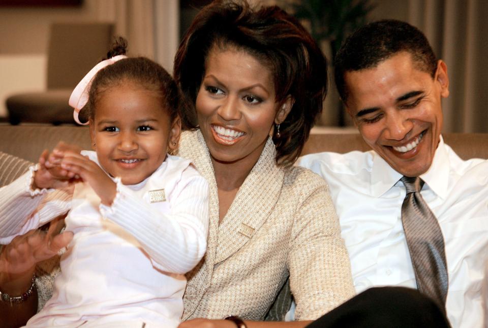 Barack and Michelle Obama with their daughter Sasha in 2004.