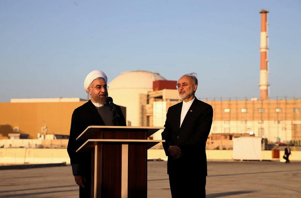 In this file photo released on Jan. 13, 2015, Iranian President Hassan Rouhani, left, and Iran's nuclear chief Ali Akbar Salehi, address journalists at the Bushehr nuclear power plant in the Gulf port city of Bushehr, Iran.