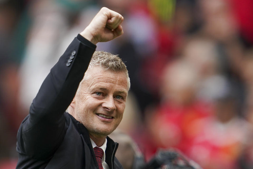 Manchester United's manager Ole Gunnar Solskjaer gestures to the crowd following the English Premier League soccer match between Manchester United and Leeds United at Old Trafford in Manchester, England, Saturday, Aug. 14, 2021. (AP Photo/Jon Super)