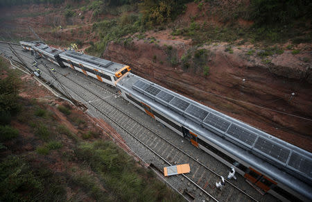 Rescue workers survey the scene after a commuter train derailed between Terrassa and Manresa, outside Barcelona, Spain, November 20, 2018. REUTERS/Albert Gea