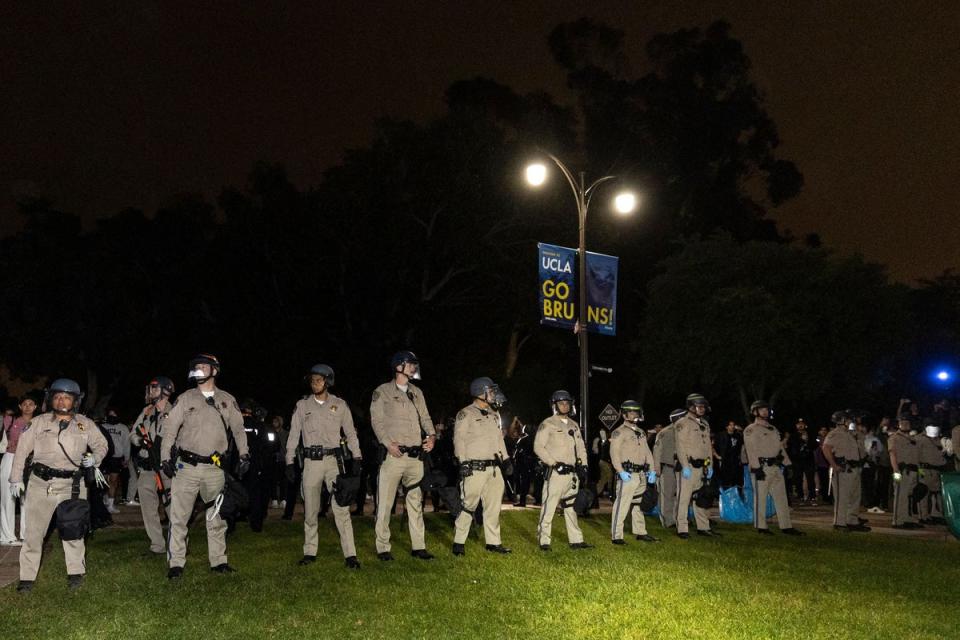 Police officers stand guard after clashes erupted on the campus of the University of California Los Angeles (AFP via Getty Images)