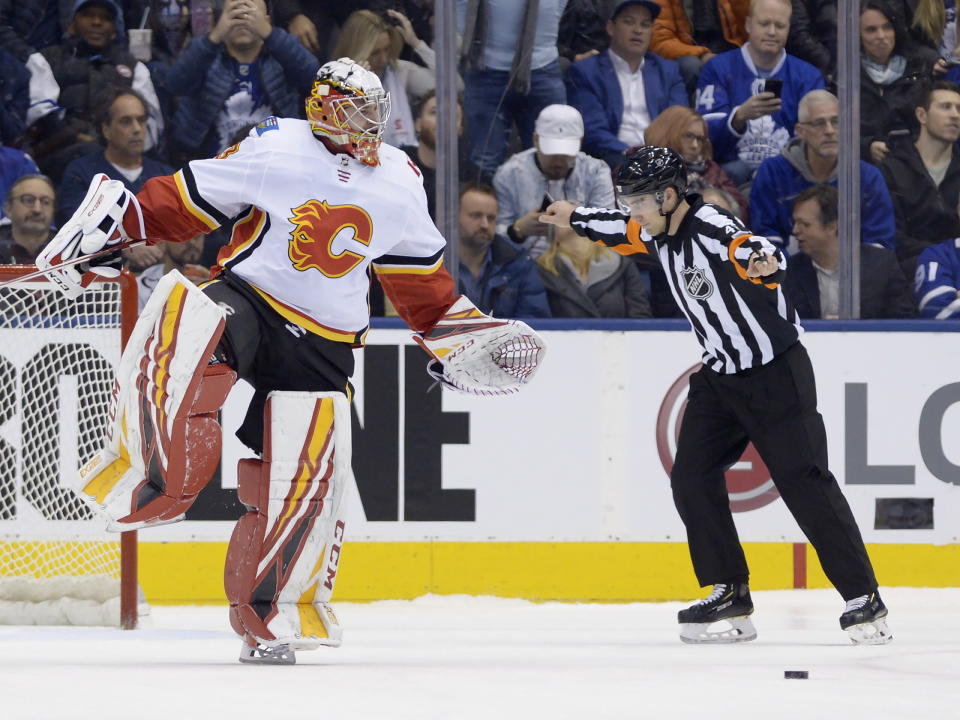 Calgary Flames goaltender David Rittich (33) reacts after making a save against the Toronto Maple Leafs in the shootout of an NHL hockey game Thursday, Jan. 16, 2020, in Toronto. (Nathan Denette/The Canadian Press via AP)