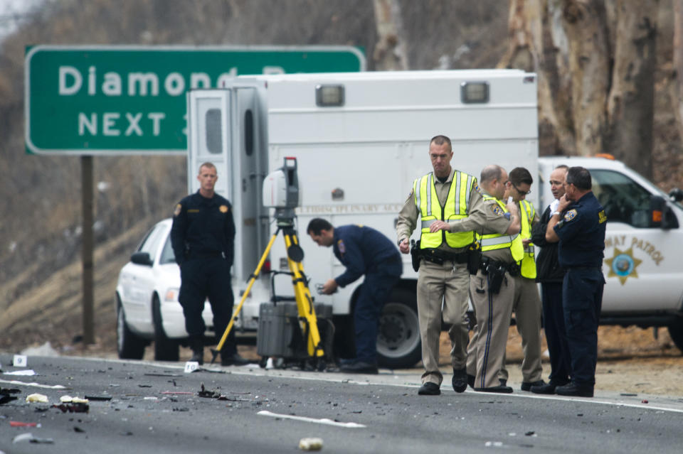 Officials investigate the scene of a multiple vehicle accident where 6 people were killed on the westbound Pomona Freeway in Diamond Bar, Calif. on Sunday morning, Feb. 9, 2013. Authorities say a wrong-way driver caused the pre-dawn crash that left six people dead. (AP Photo/San Gabriel Valley Tribune,Watchara Phomicinda) MAGS OUT, NO SALES MANDATORY CREDIT