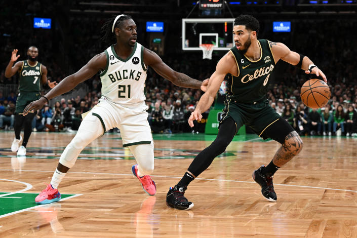 BOSTON, MASSACHUSETTS - DECEMBER 25: Jayson Tatum #0 of the Boston Celtics dribbles the ball against Jrue Holiday #21 of the Milwaukee Bucks during the first quarter at the TD Garden on December 25, 2022 in Boston, Massachusetts. NOTE TO USER: User expressly acknowledges and agrees that, by downloading and or using this photograph, User is consenting to the terms and conditions of the Getty Images License Agreement. (Photo by Brian Fluharty/Getty Images)