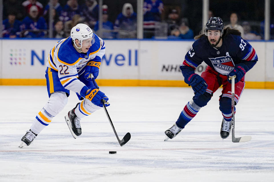 New York Rangers center Mika Zibanejad (93) pursues as Buffalo Sabres right wing Jack Quinn (22) skates with the puck during the first period of an NHL hockey game in New York, Saturday, Dec. 23, 2023. (AP Photo/Peter K. Afriyie)