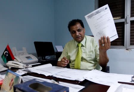 Mukhtar Al-Habbas, the general manager of Tripoli Central Hospital, shows a document during an interview with Reuters in Tripoli, Libya, July 18, 2016. Picture taken July 18, 2016. REUTERS/Ismail Zitouny