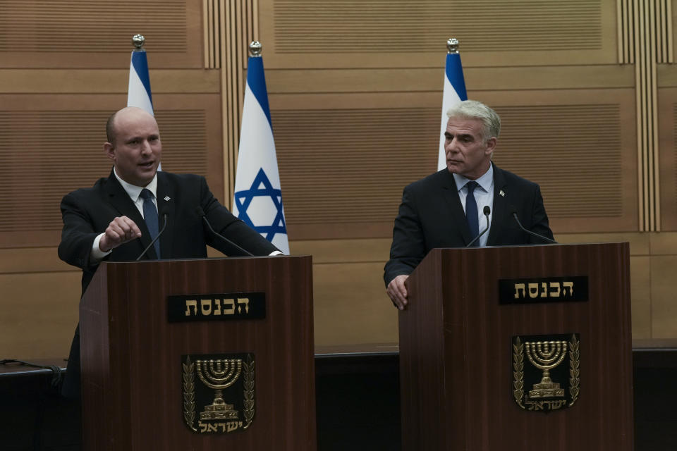Israeli Prime Minister Naftali Bennett, left, speaks during a joint statement with Foreign Minister Yair Lapid, at the Knesset, Israel's parliament, in Jerusalem, Monday, June 20, 2022. Bennett's office announced Monday, that his weakened coalition will be disbanded and the country will head to new elections. Bennett and his main coalition partner, Yair Lapid, decided to present a vote to dissolve parliament in the coming days, Bennett's office said. Lapid is then to serve as caretaker prime minister. The election, expected in the fall, would be Israel's fifth in three years. (AP Photo/Maya Alleruzzo)