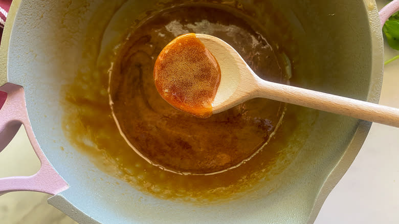 spoon of glaze over pot