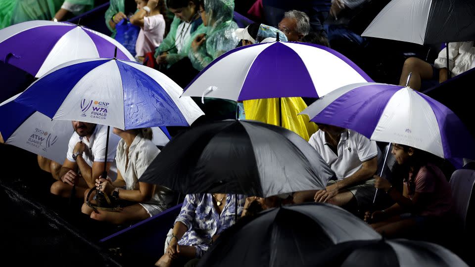 Spectators sit in the rain during the semifinal between Jessica Pegula and Coco Gauff. - Sarah Stier/Getty Images