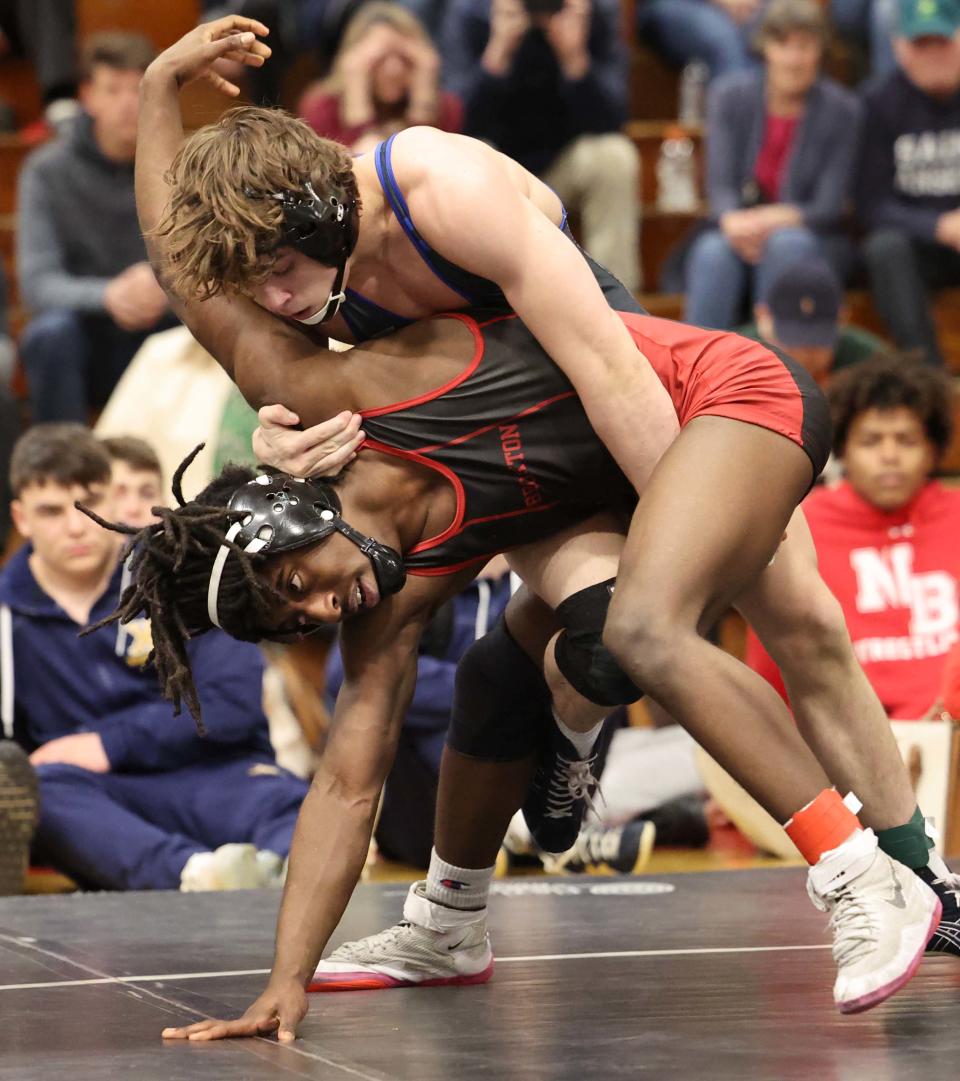 From left, Brockton's Mark Lattimore, bottom, versus Braintree's Drew McGourty during the division one south sectional wrestling championships at Brockton High School on Saturday, Feb. 11, 2023.