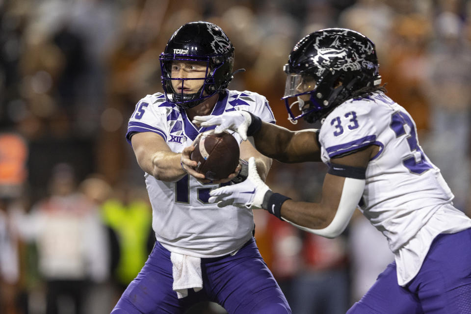 TCU quarterback Max Duggan (15) hands off to running back Kendre Miller (33) during the second half of the team's NCAA college football game against Texas on Saturday, Nov. 12, 2022, in Austin, Texas. (AP Photo/Stephen Spillman)