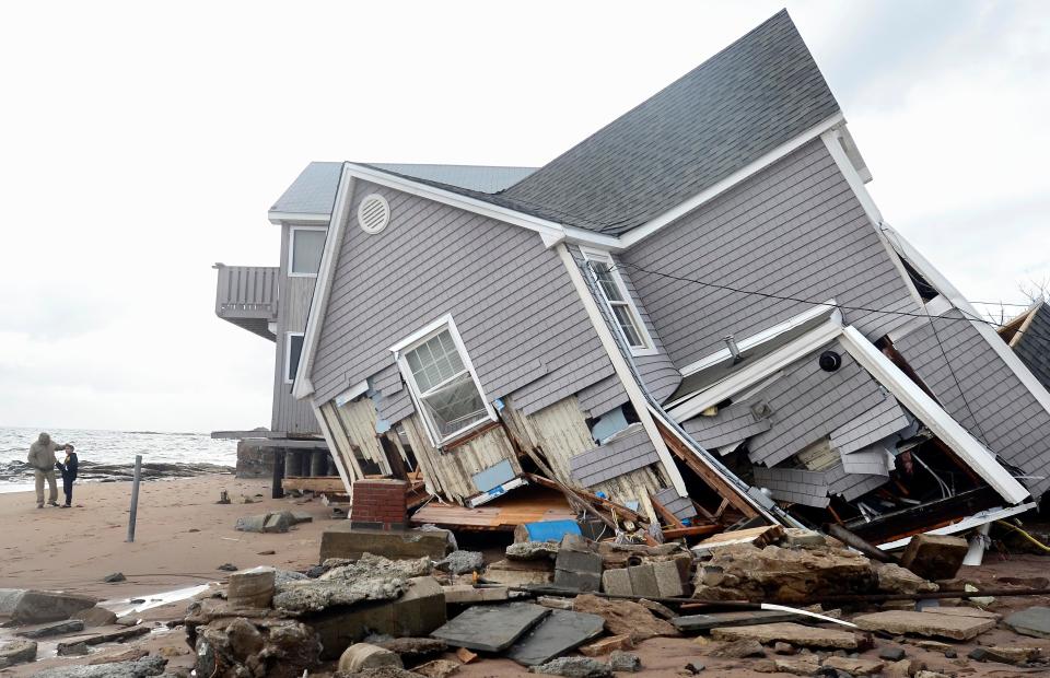 a home leans, destroyed in Hurricane Sandy in Connecticut