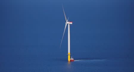 FILE PHOTO: A support vessel is seen next to a wind turbine at the Walney Extension offshore wind farm operated by Orsted off the coast of Blackpool, Britain September 5, 2018. REUTERS/Phil Noble/File Photo