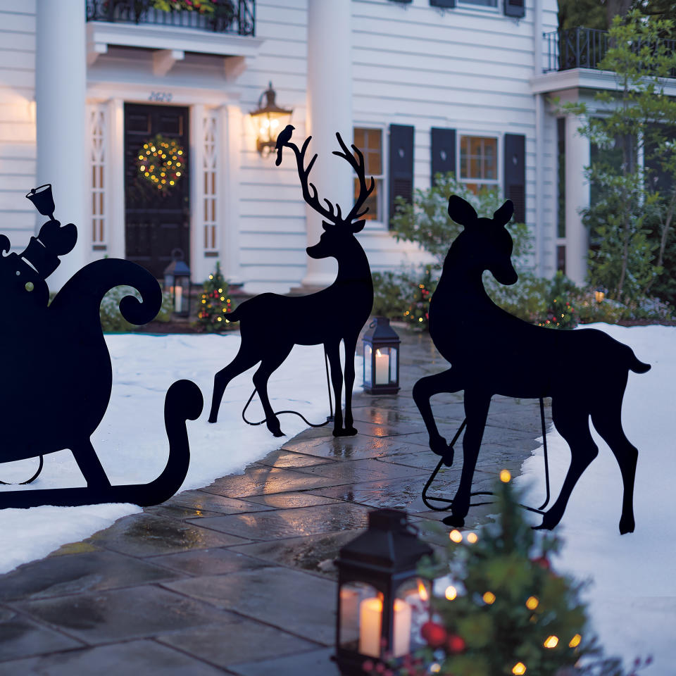 This image provided by Grandin Road shows their powdercoated deer silhouettes. The silhouttes make a striking impact on a front yard's seasonal décor scheme, especially against a snowy backdrop. Depending on how you accessorize, they can look modern, traditional or give a winter cabin vibe. www.grandinroad.com (Grandin Road via AP)