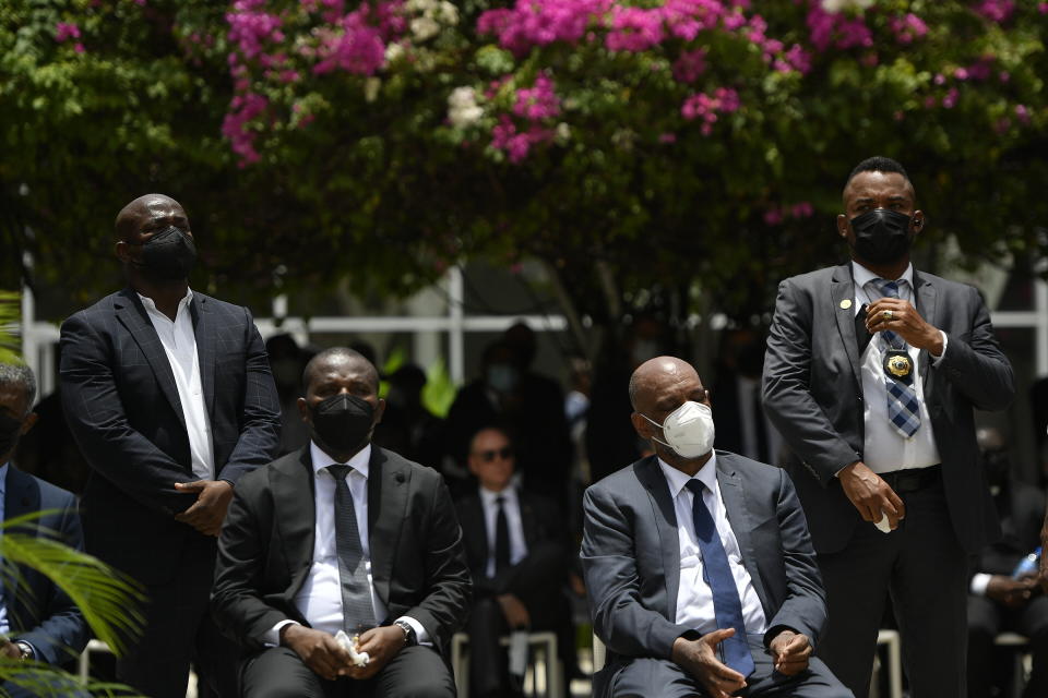 Interim Prime Minister Claude Joseph, sitting left, and designated Prime Minister Ariel Henry attend a memorial service for late Haitian President Jovenel Moise at the National Pantheon Museum in Port-au-Prince, Haiti, Tuesday, July 20, 2021. Henry is expected to be sworn in later in the day to replace Joseph, who assumed leadership of Haiti with the backing of police and the military after the July 7 attack at Moïse's private home. (AP Photo/Matias Delacroix)