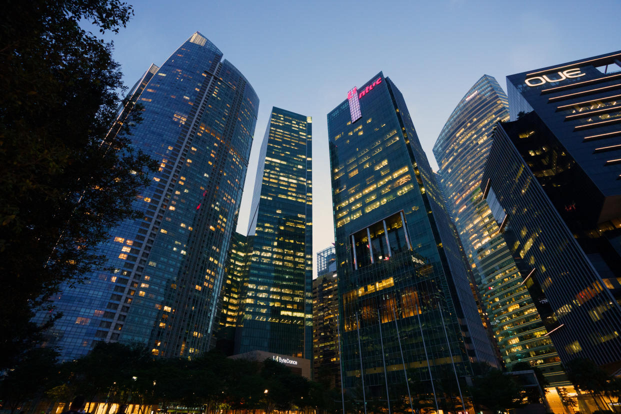 Commercial buildings in the central business district at dusk in Singapore, on Thursday, April 11, 2024. Singapore's central bank kept its monetary policy unchanged for a fourth straight time on still-elevated price pressures, a decision seen by some economists as indicative that tight settings will probably stay in the months ahead. (Photo: Ore Huiying/Bloomberg)