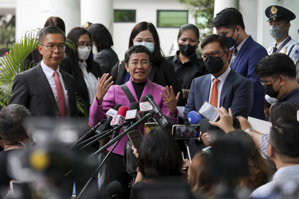 Filipino journalist Maria Ressa, center, one of the winners of the 2021 Nobel Peace Prize and Rappler CEO, speaks to the media after a court decision at the Court of Tax Appeals in Quezon City, Philippines Wednesday, Jan. 18, 2023. The tax court on Wednesday cleared Ressa and her online news company of tax evasion charges she said were part of a slew of legal cases used by former President Rodrigo Duterte to muzzle critical reporting. (AP Photo/Basilio Sepe)