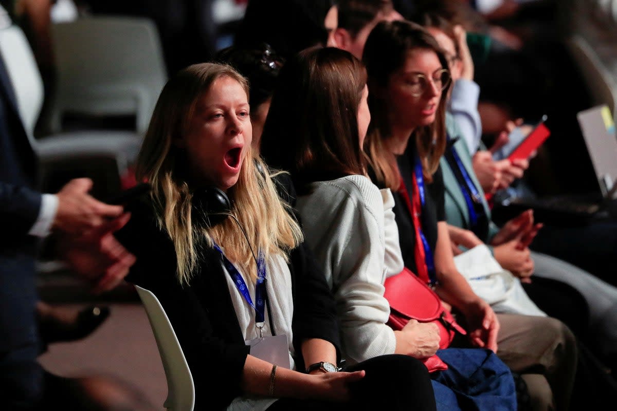 A Cop28 delegate yawns as negotiations continued into the early hours of Tuesday (Reuters)