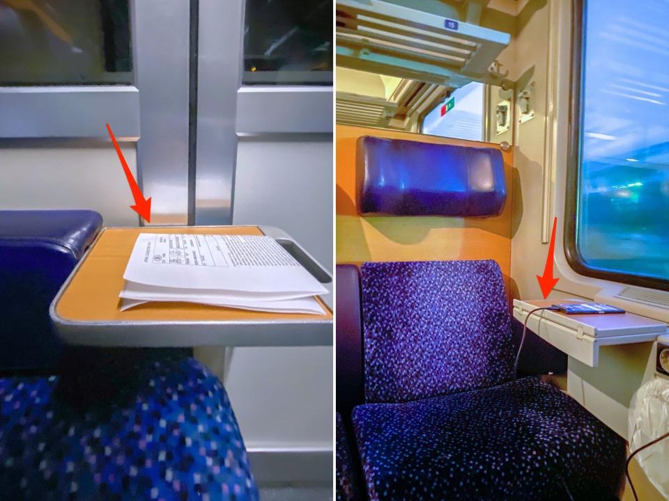 Left: A close up of a mini wood table attached to the arm of a blue chair. There are papers on the table. Right: A plush, blue train seat to the right of a window on a train with a side table holding a charging phone beneath the window.