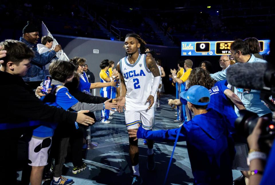 UCLA guard Dylan Andrews runs onto the court at Pauley Pavilion before a game against Oregon State on Thursday.