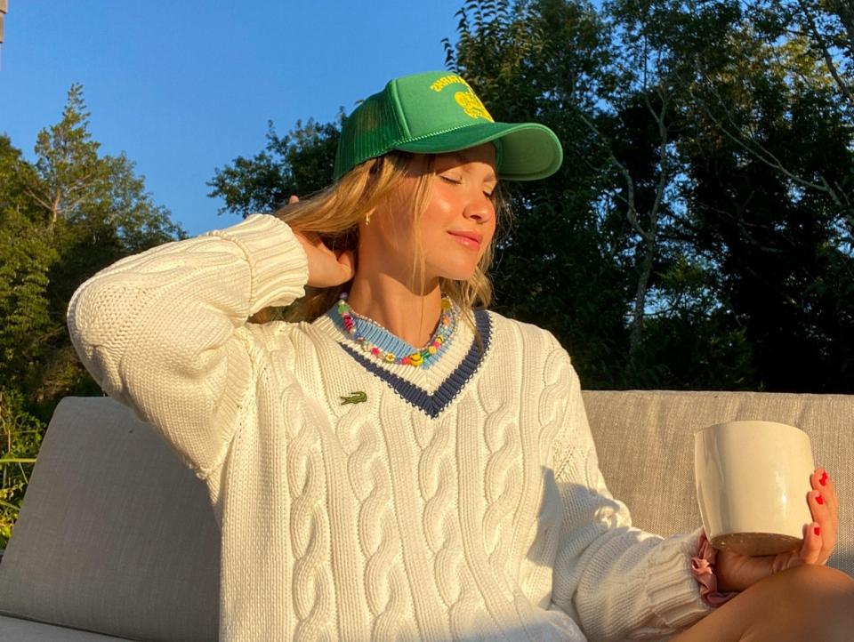 Meredith Hayden sits outside holding a mug