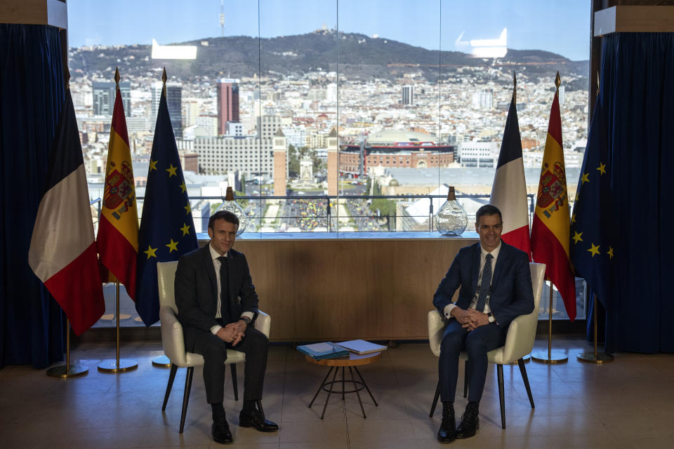 French President Emmanuel Macron, left, talks with Spanish counterpart Pedro Sánchez in Barcelona, Spain, on Thursday, Jan. 19, 2023. A summit between the Spanish and French governments, led by their executive leaders, prime minister Pedro Sánchez and president Emmanuel Macron, is held in the capital of Catalonia to strengthen relations between the European neighbors by signing a friendship treaty. (AP Photo/Emilio Morenatti)