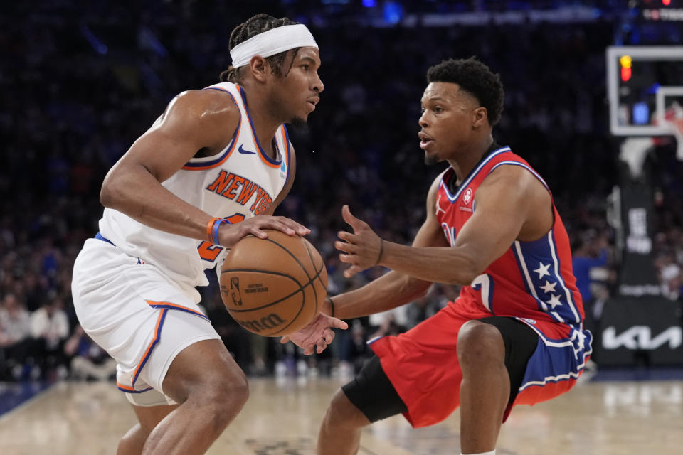 New York Knicks guard Miles McBride, left, drives against Philadelphia 76ers guard Kyle Lowry, right, during the second half in Game 1 of an NBA basketball first-round playoff series, Saturday, April 20, 2024, at Madison Square Garden in New York. (AP Photo/Mary Altaffer)