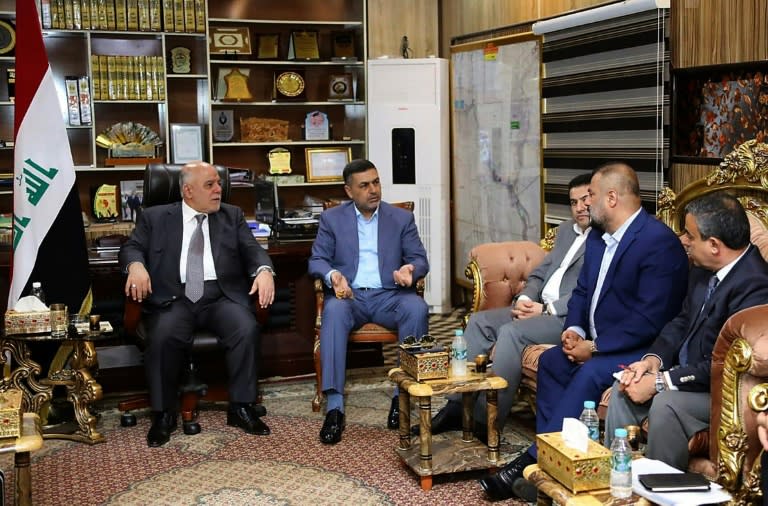 Iraqi Prime Minister Haider al-Abadi (L) meets with local officials in the southern city of Basra on September 10, 2018