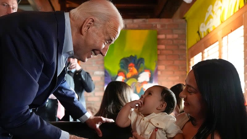 President Joe Biden greets people at a campaign event at El Portal restaurant Tuesday, March 19, 2024, in Phoenix.