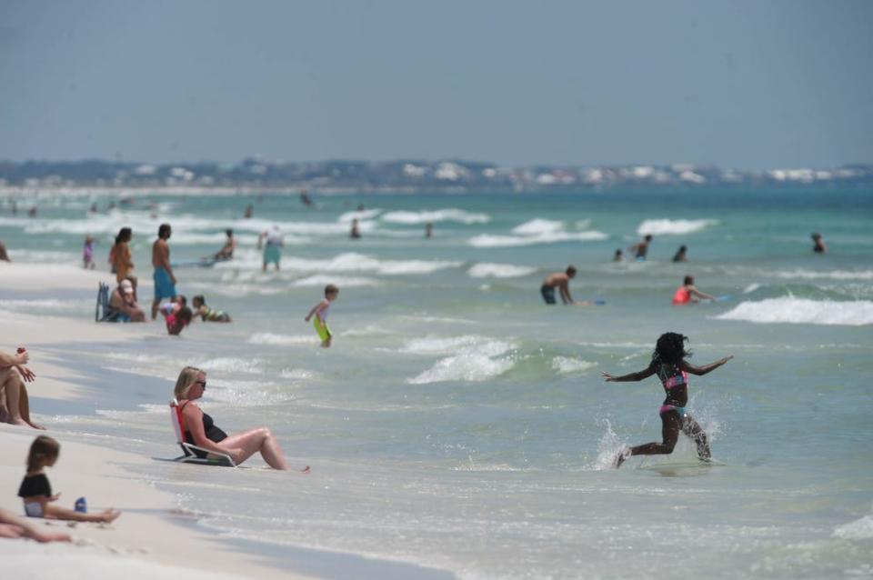 Beachgoers enjoy a day in Miramar Beach. Next month, Walton County commissioners will consider proposed changes to the county's beach activities ordinance.