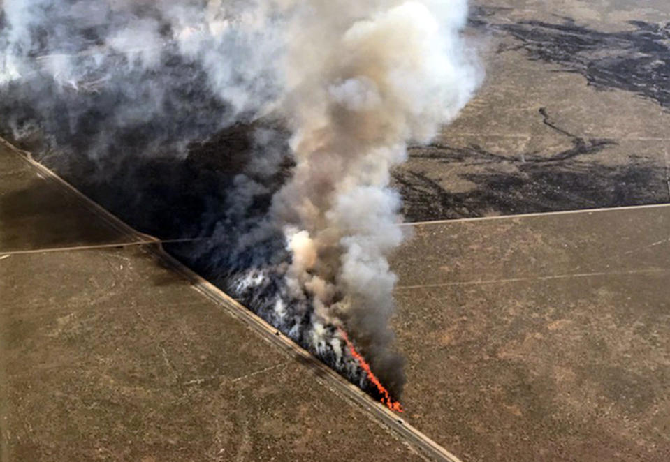 This photo provided by the U.S. Bureau of Land Management (BLM) shows wildfires burning in Idaho, Wednesday, July 24, 2019. The largest wildfire at the nation's primary nuclear research facility in recent history had been burning close to buildings containing nuclear fuel and other radioactive material, but a change in wind direction Wednesday was pushing the flames into open range at the sprawling site in Idaho, officials said. The lightning-caused fire at the Idaho National Laboratory is one of several across the U.S. West. (Bureau of Land Management via AP)