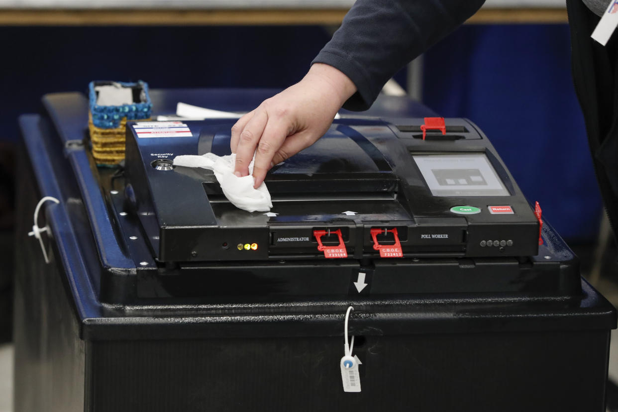 An election official cleaned a voting machine in Chicago as Illinois proceeded with its presidential primary on Tuesday. (Photo: KAMIL KRZACZYNSKI via Getty Images)