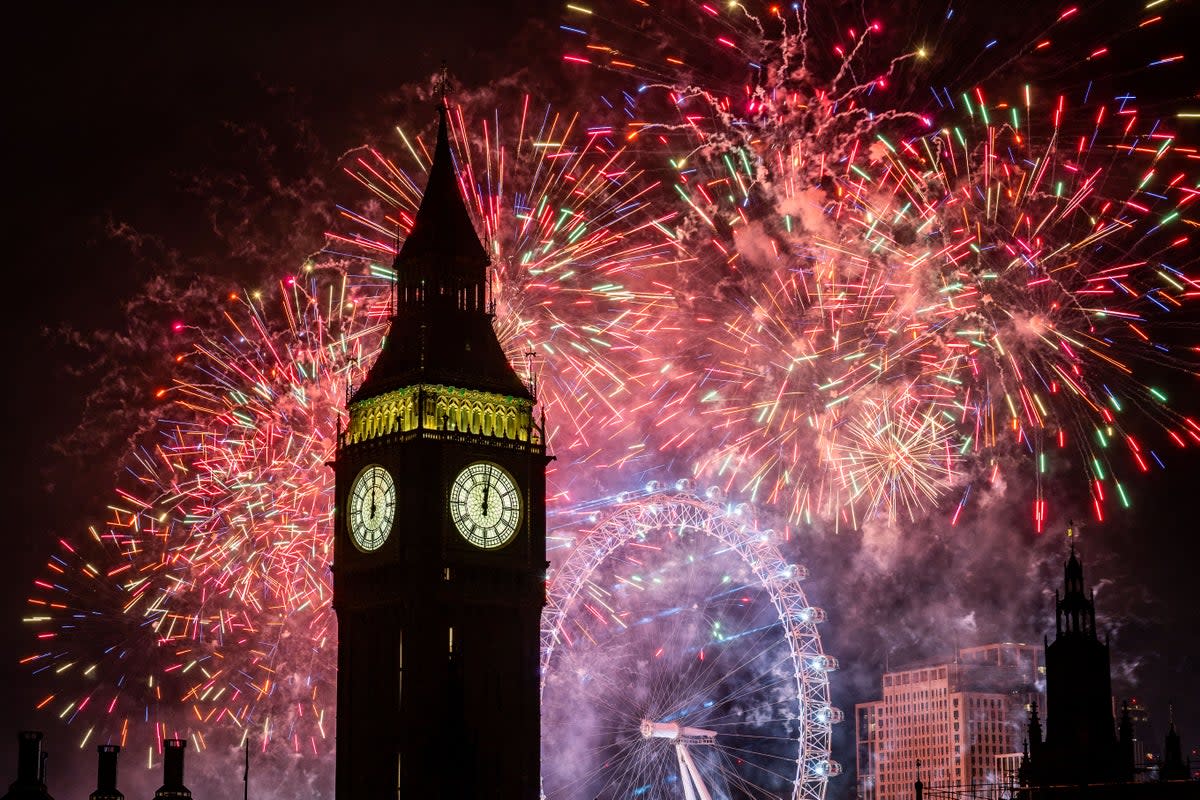 Fireworks light up the sky over the London Eye and the Elizabeth Tower (Big Ben) in central London during the New Year celebrations  (PA Wire)