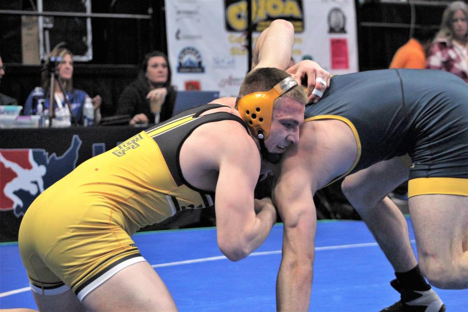 Sully DeHerrera of Pueblo East grasps the head of Adrian Casillas of Frederick High School during the first round of the CHSAA Class 4A state wrestling tournament held at Ball Arena on Feb. 16, 2023.