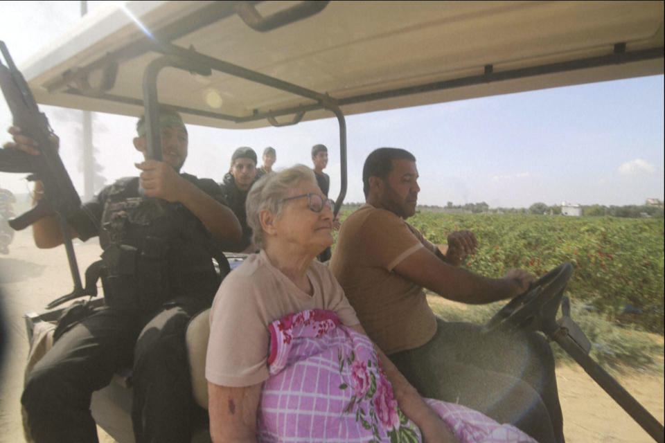 FILE - In this still image taken from video, Hamas' militants transport Yaffa Adar, 85, an Israeli civilian kidnapped from Nir Oz, into Gaza strip in a golf cart, in an unspecified location between Israel and Gaza, on Saturday Oct. 7, 2023. Yaffa Adar was among those released Friday, Nov. 24. (AP Photo/FILE)