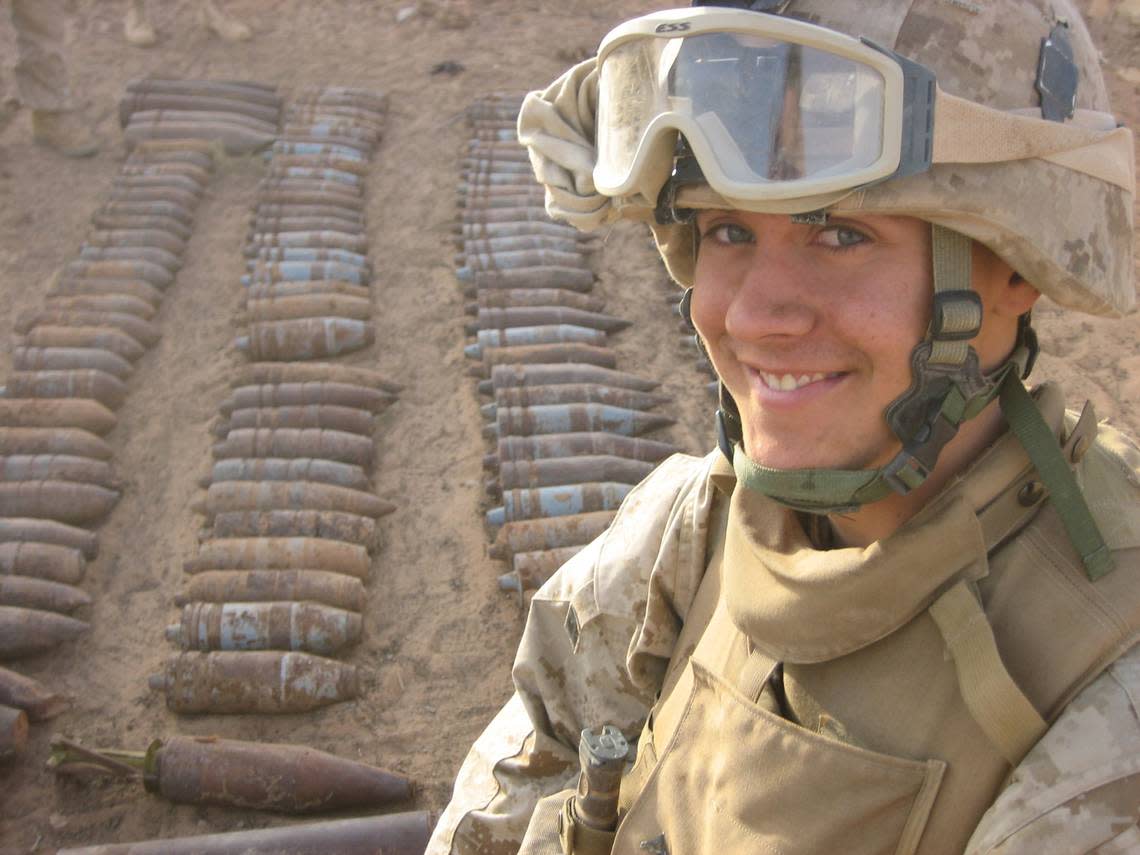 Marine Lance Cpl. Nick Ramey guards a weapons cache seized from insurgents in Iraq. The weapons were later destroyed by U.S. forces.