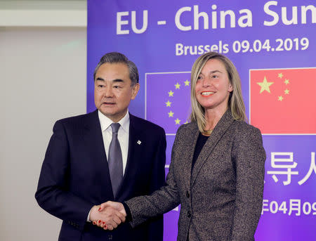 Chinese Foreign Minister Wang Yi is welcomed by Federica Mogherini, High Representative for Foreign Affairs and Security Policy ahead of a meeting at the European Council in Brussels, Belgium, April 9, 2019. Olivier Hoslet/Pool via REUTERS