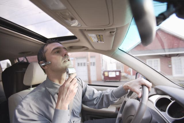 Businessman Shaving While Driving