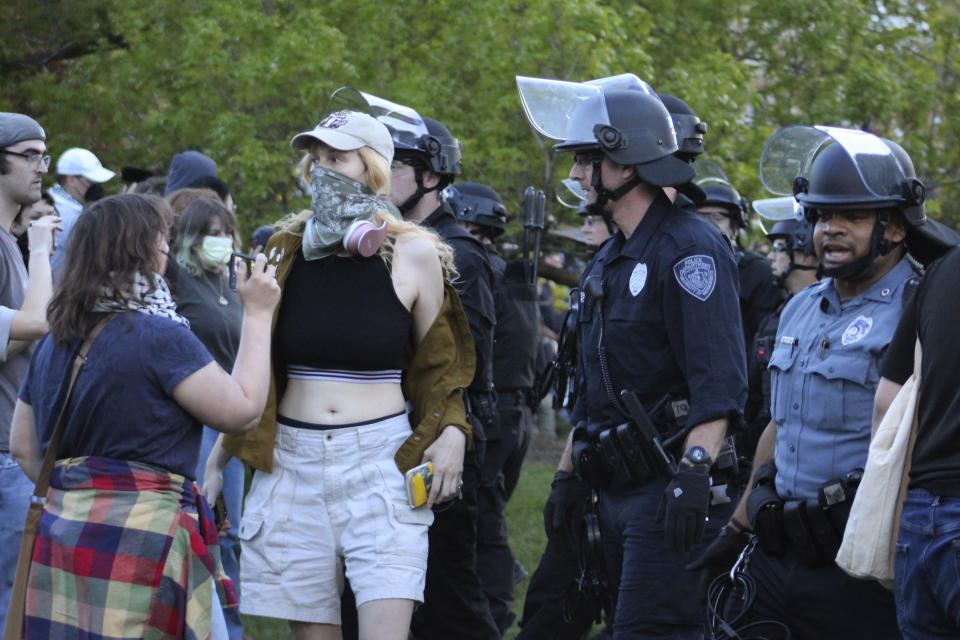 Students and supporters are confronted by members of law enforcement, Tuesday, May 7, 2024, on the University of Massachusetts Amherst campus, in Amherst, Mass. Police moved in Tuesday night to break up an encampment at the school in what appeared in video to be an hours-long operation as dozens of police officers in riot gear systematically tore down tents and took protesters into custody. The protesters established the tent encampment to demonstrate against the war in Gaza. (Kalinka Kornacki via AP)