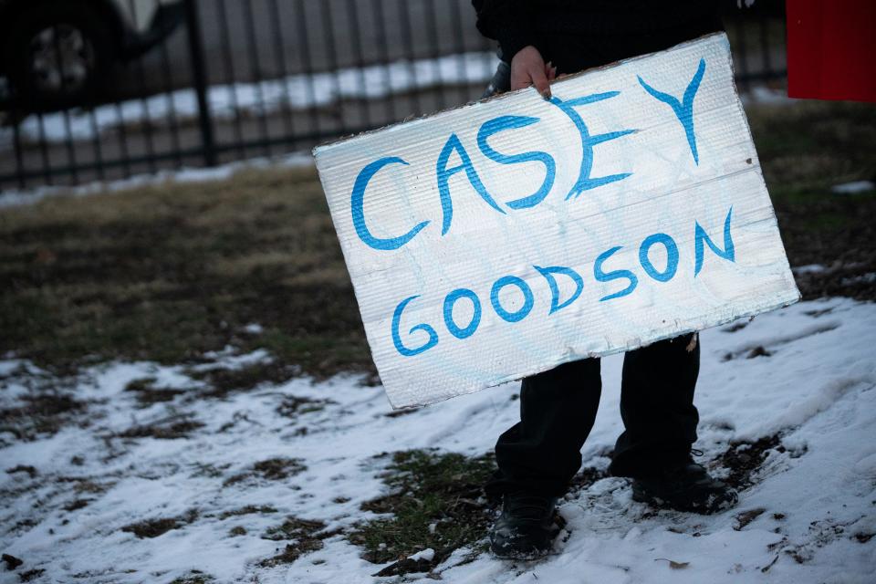 An attendee holds a sign during a gathering at the basketball courts in Thompson Park that was organized in support of the family of Casey Goodson Jr. days after a mistrial was declared in the trial of ex-deputy Jason Meade.