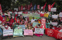 Members of All India Kisan Sangharsh Coordination Committee (AIKSCC) and activists of left parties and trade unions participate in a nationwide protest in Hyderabad, India, Friday, Sept. 25, 2020. Hundreds of Indian farmers took to the streets on Friday protesting new laws that the government says will boost growth in the farming sector through private investments, but they fear these are likely to be exploited by private players for buying their crops cheaply. (AP Photo/Mahesh Kumar A.)