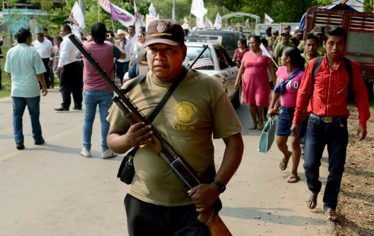 A vigilante stands guard during a meeting held by senate candidate Nestora Salgado in San Luis Acatlan, Mexico on May 20, 2018